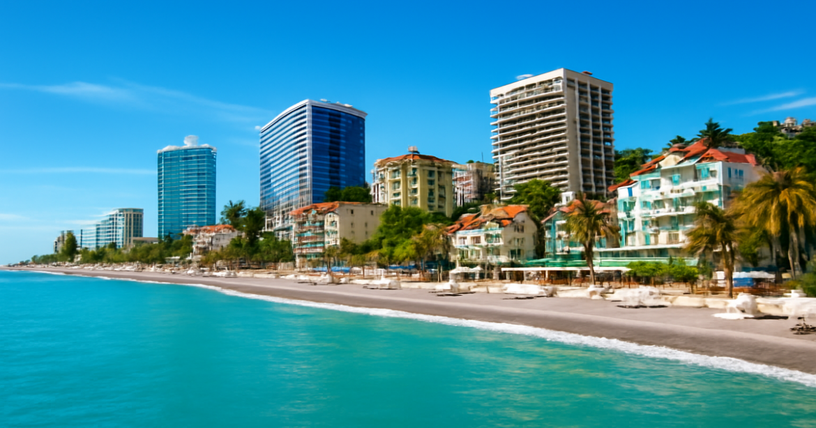 Explore the best отели в Сочи with this vibrant coastal view showcasing various accommodations.